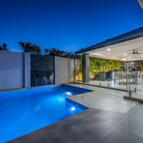 Back yard of a property with a pool.