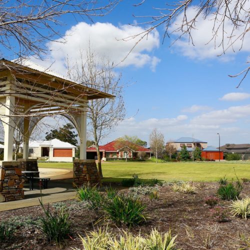 Park with a veranda and seating area.