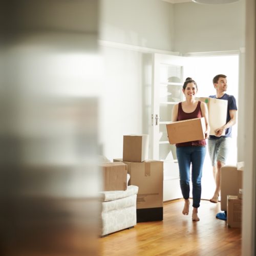 Couple walking into new house.