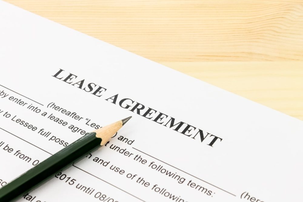 A tenancy agreement document ready for signing, highlighting a key responsibility of a property manager.