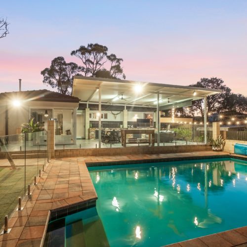 Backyard of a house with a pool.