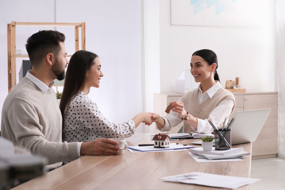 Young couple having a meeting with property agent.