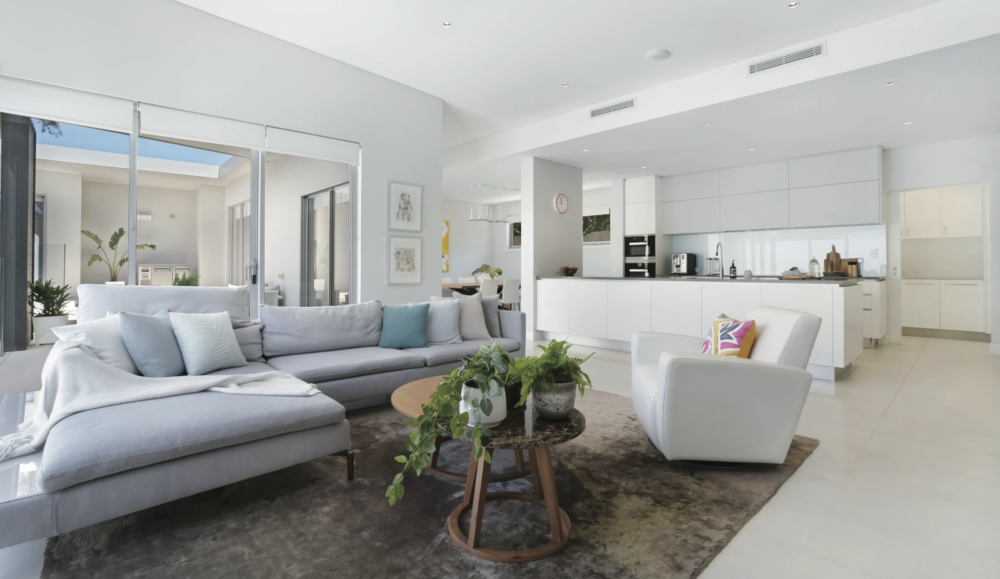 Living room of a modern house styled with white and grey.