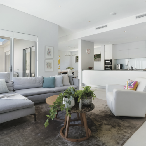 Living room of a modern house styled with white and grey.